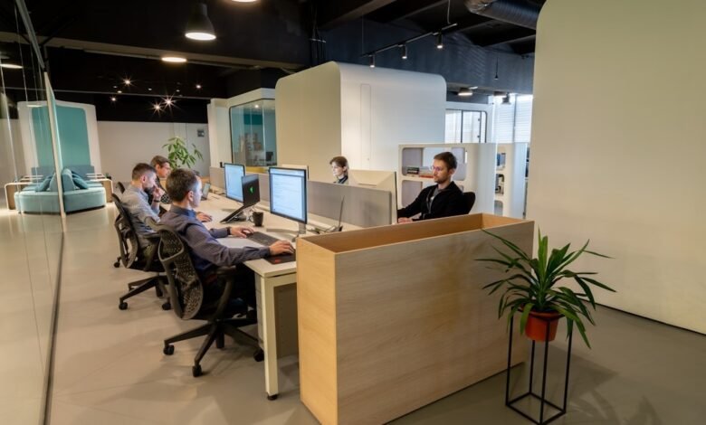 Office interior featuring people working at desks, focused on a proposal automation tool for enhanced productivity.